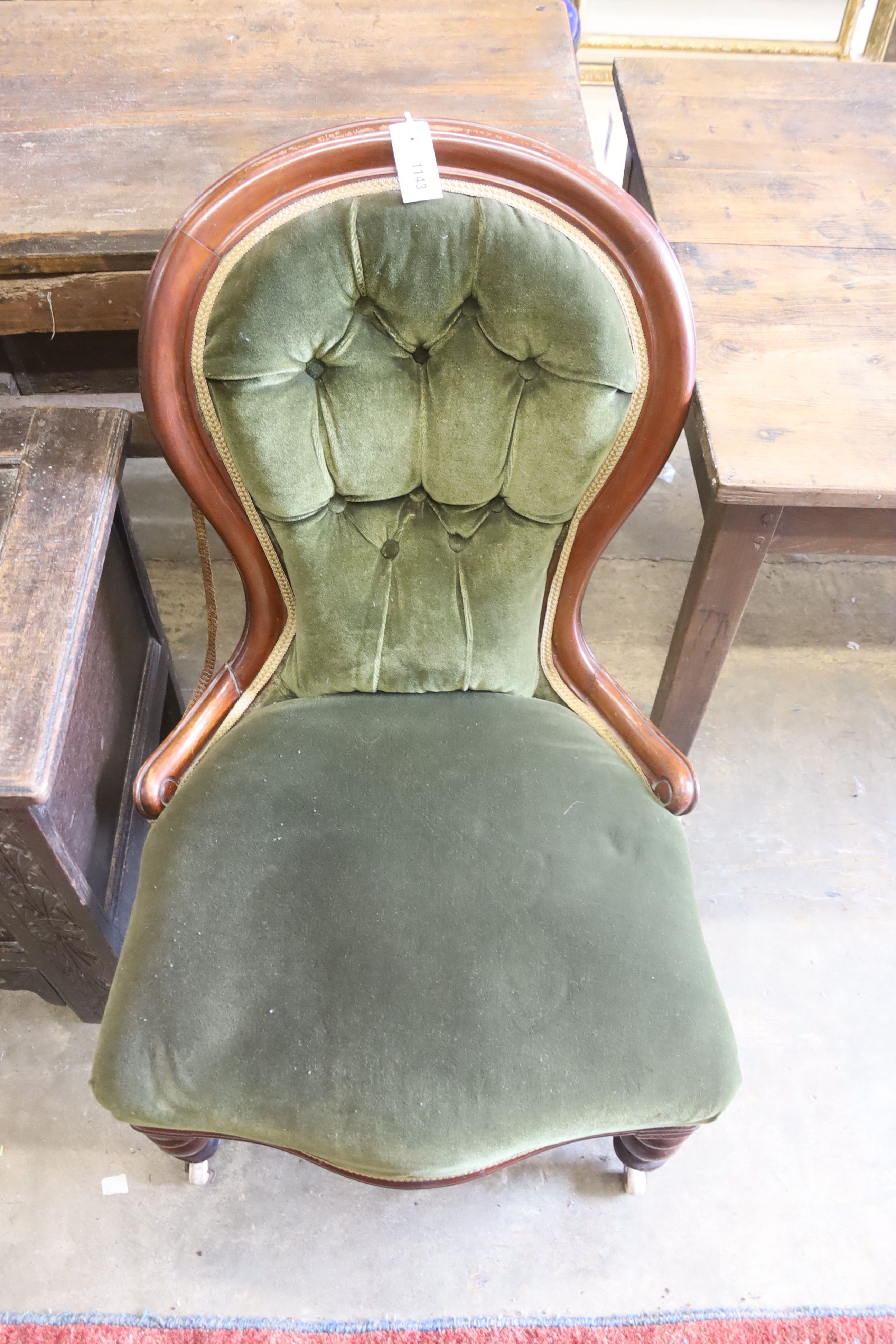 A Victorian mahogany spoon back nursing chair and a Victorian walnut spoonback nursing chair